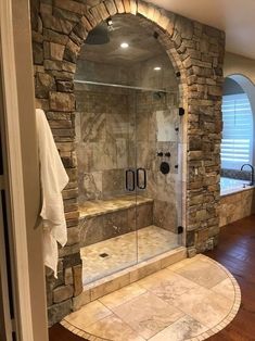 a bathroom with stone walls and a walk in shower