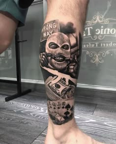 a man's leg with tattoos on it and an image of a person wearing a mask