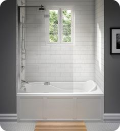 a bathroom with white tile walls and flooring, along with a wooden bench in front of the bathtub