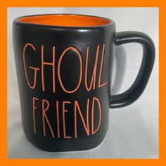 a black and orange coffee mug with the words ghoul friend written on it