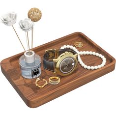 an assortment of jewelry on a wooden tray