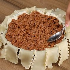 a person scooping some food out of a dish