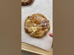 two cookies sitting on top of paper next to each other