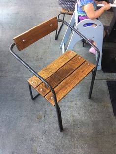 two children are sitting at a table with chairs and one child is using a laptop