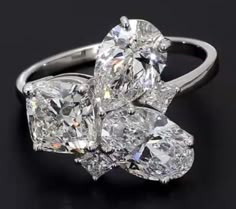 an engagement ring with three pear shaped diamonds