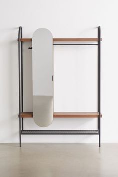 a skateboard mounted to the side of a wooden shelf next to a white wall