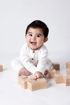 a baby is playing with wooden blocks on the floor