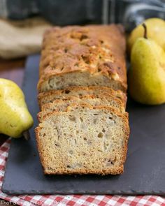 sliced loaf of banana bread with pears in the background