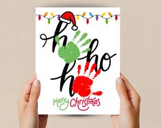 two hands holding up a christmas card with the words oh hoo and hand prints on it