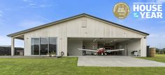 an airplane is parked in the garage of a house that has been built for sale