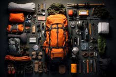 the contents of a backpack laid out on a table with hiking gear and equipment around it