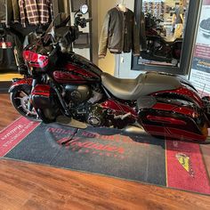 a red motorcycle is on display in a store