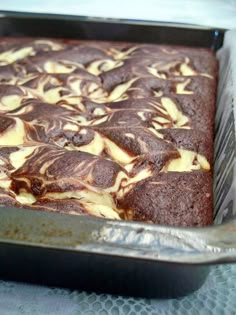 a cake in a pan with chocolate and white icing