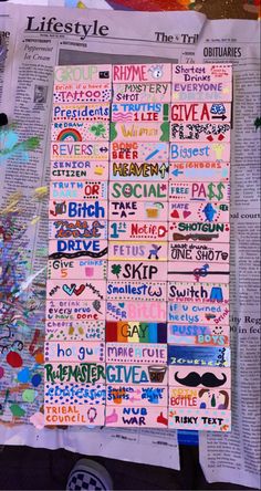 the newspaper is covered with many different types of stickers and words that spell out their names