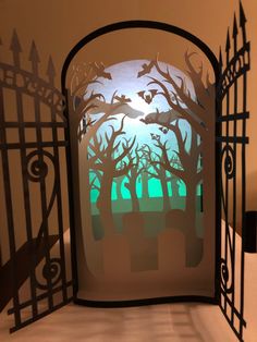 a paper cut gate with trees and bats on it