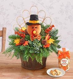 a wooden table topped with a potted plant filled with flowers and a stuffed animal