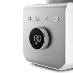 an alarm clock sitting on top of a silver and white device with the time displayed