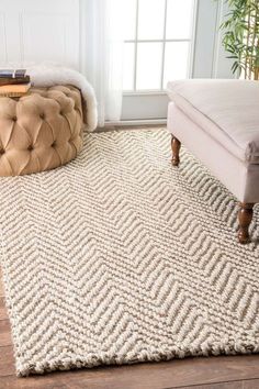 a white rug on the floor in front of a window