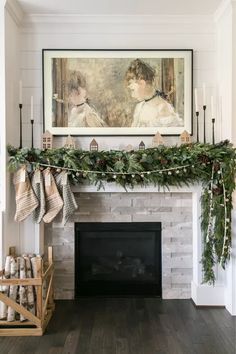 a fireplace decorated for christmas with stockings hanging from the mantel