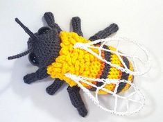 a crocheted bee with a net on it's back