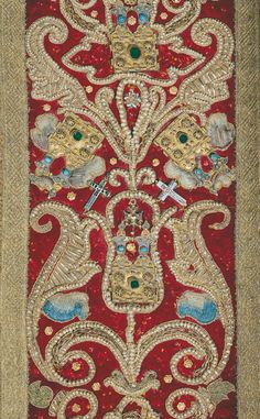 an intricately designed red and gold wall hanging