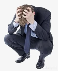 a man in a suit and tie holding his head