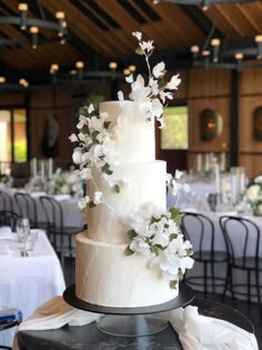 a wedding cake with white flowers on top