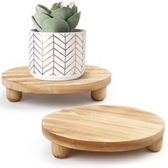 two small wooden plant stands with succulents in the top one on each side