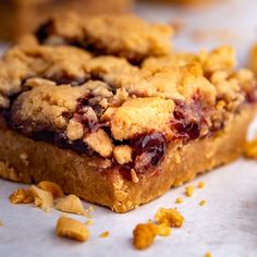 a piece of cake with crumbs on top of it and some other food in the background