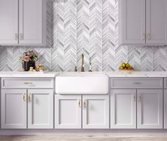 a kitchen with white cabinets and marble counter tops, along with a herringbone tile backsplash