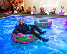 a man sitting on an inflatable pool float