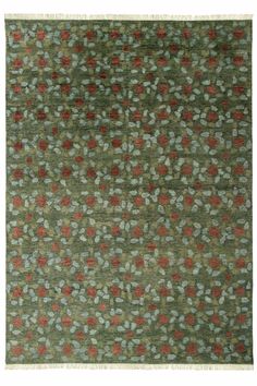 a green rug with red and white flowers on it