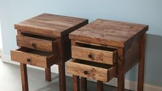 two wooden tables with drawers on each side