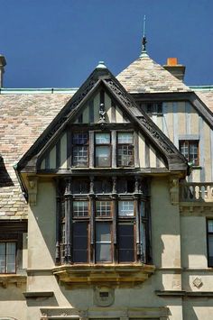 an old building with many windows and a clock on the top of it's roof