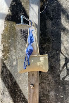 a blue bag hanging from a wooden pole