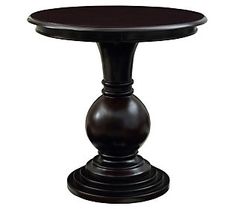 a round wooden table with two pedestals at the top and one on the bottom