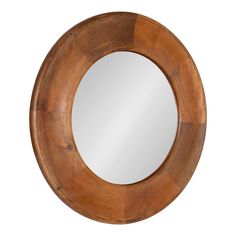 a round mirror sitting on top of a wooden table