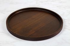 a wooden plate sitting on top of a white counter