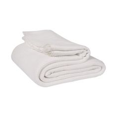 the white blanket is folded on top of each other and ready to be used as a bed