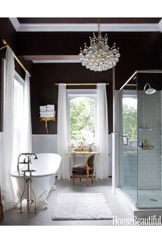 an open magazine with a bathtub, sink and shower in front of a window