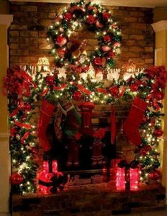 a fireplace decorated for christmas with stockings and stockings