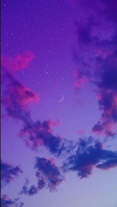 the night sky is purple and blue with stars in it, as well as some clouds