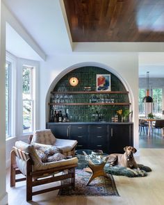 a dog laying on top of a rug in a living room