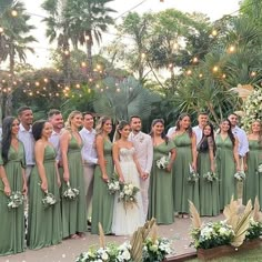 a group of people standing next to each other in front of some trees and lights