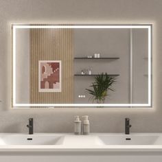 a bathroom with two sinks and a large mirror over it's wall mounted faucet