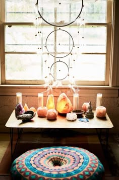 a table topped with candles next to a window