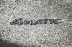 the word 4 matic written in black and white letters on a cement surface with grass