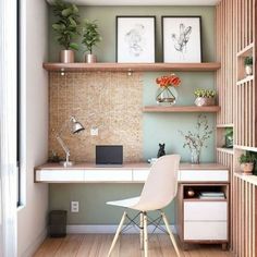 a room with a desk, shelves and pictures on the wall next to a window