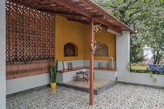 an outdoor seating area with tiled floors and walls