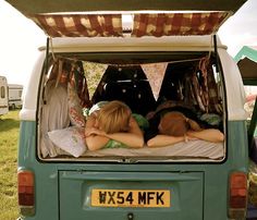 two children sleeping in the back of a van